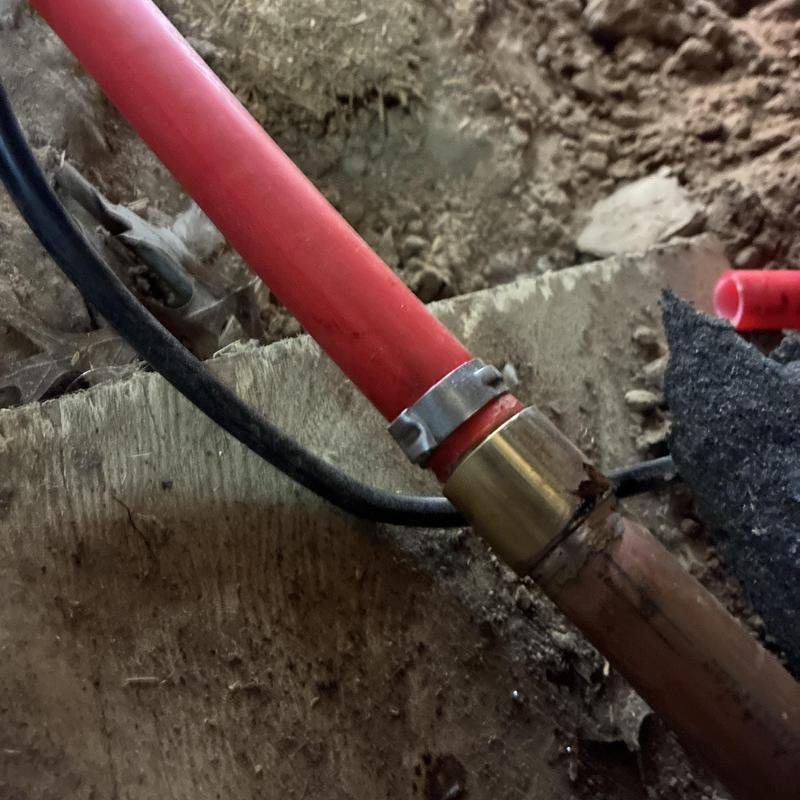Copper pipe leak repair with clamp on floor