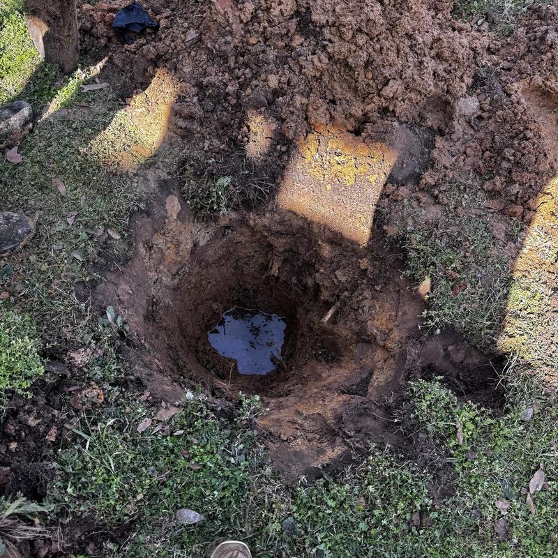 Septic tank excavation with visible water in hole