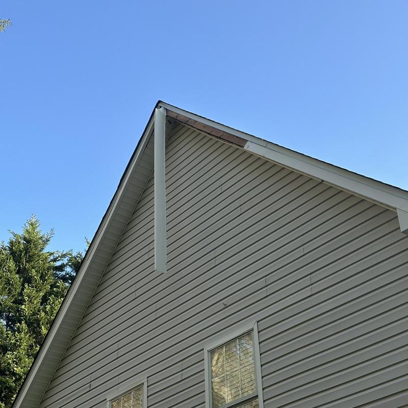 Fascia metal section damaged near roof peak