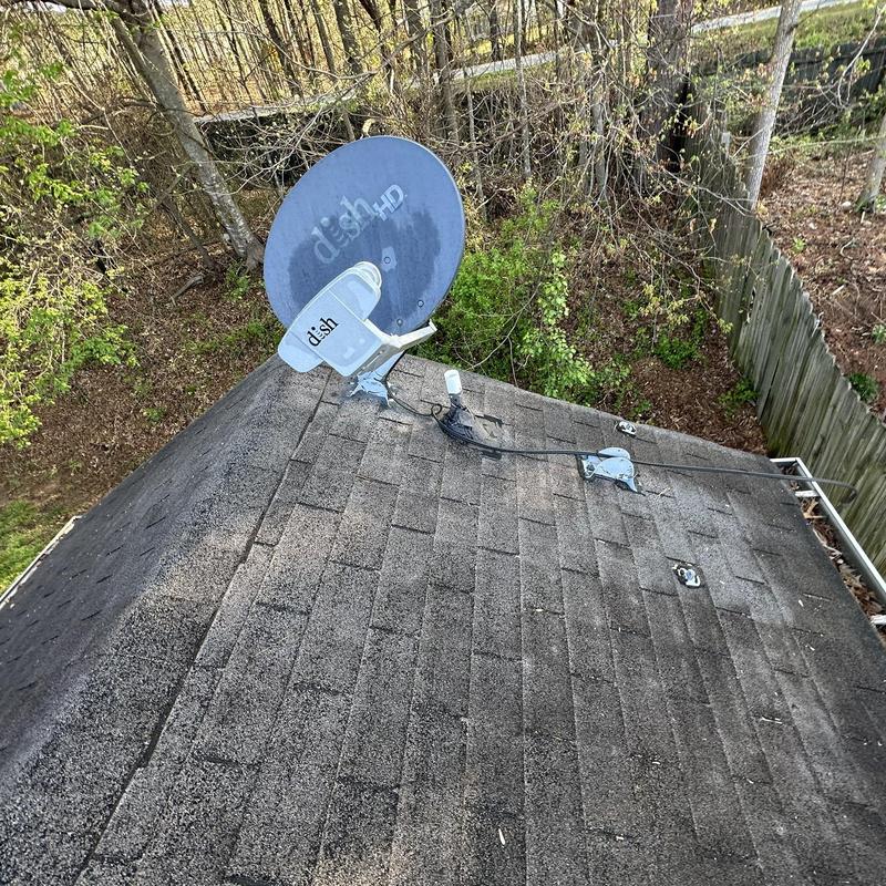 Roof shingles with old satellite and deteriorated pipe boots
