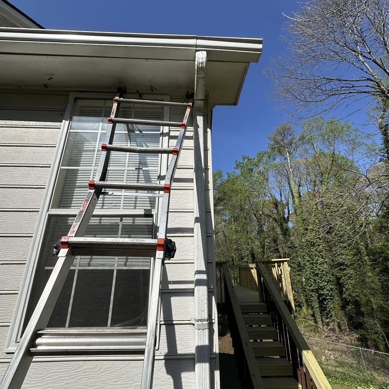 Downspout connection with ladder on house exterior