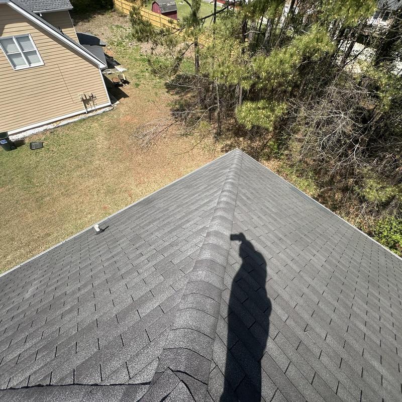 Roof ridge caps and shingles on pitched roof