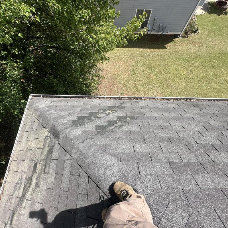Roof shingles and ridge caps with visible damage