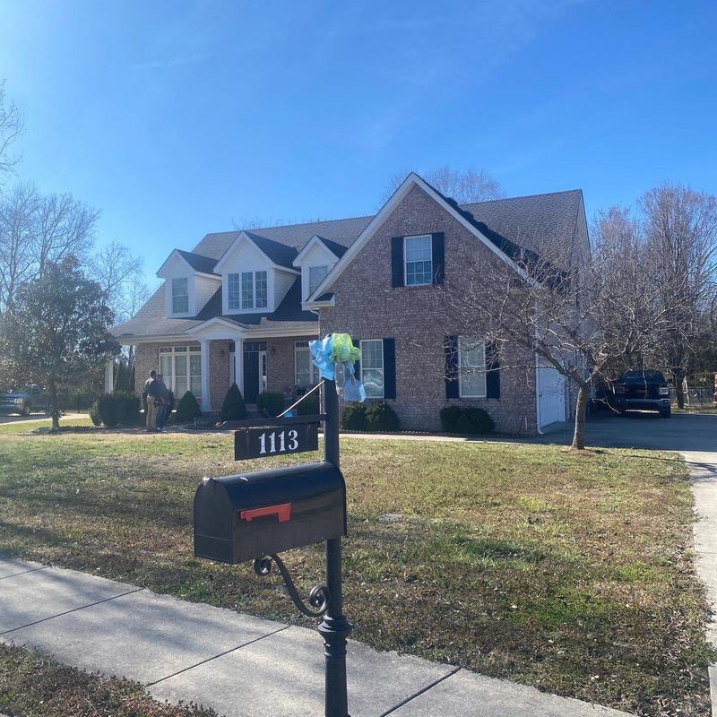 Roof shingles hail damage inspection at brick home