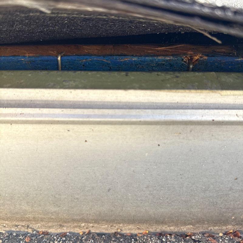 Gutter fascia with damaged wood and debris buildup
