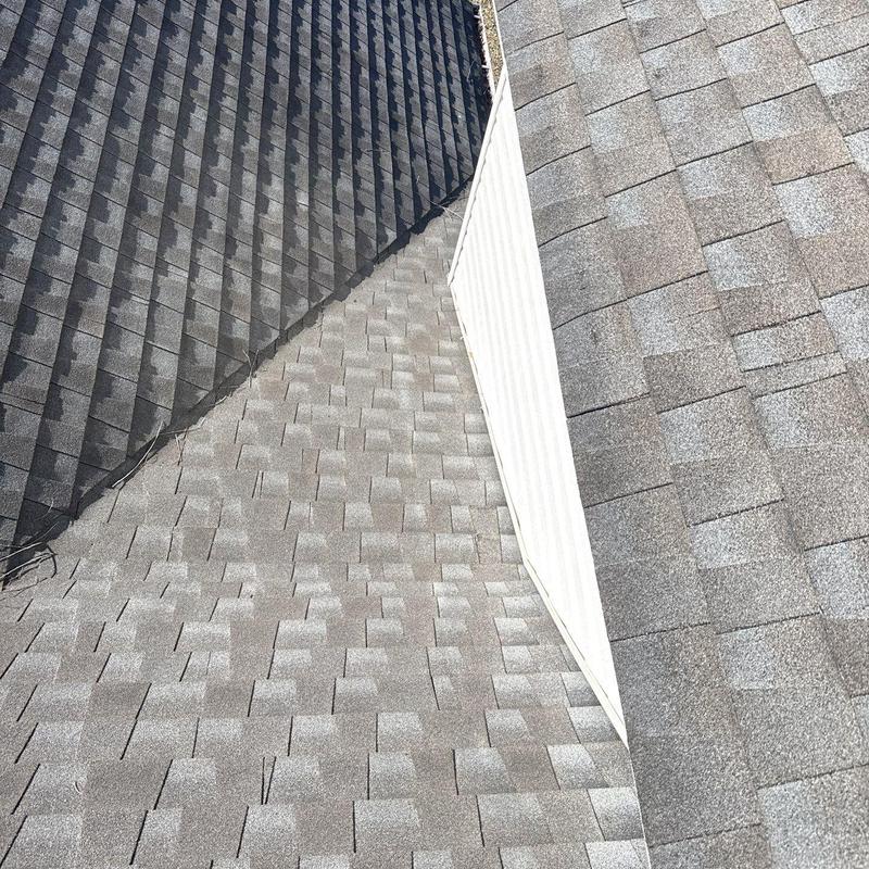 Asphalt shingle roof with metal flashing and hail damage