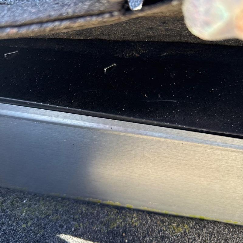 Metal roof flashing with granule loss and debris