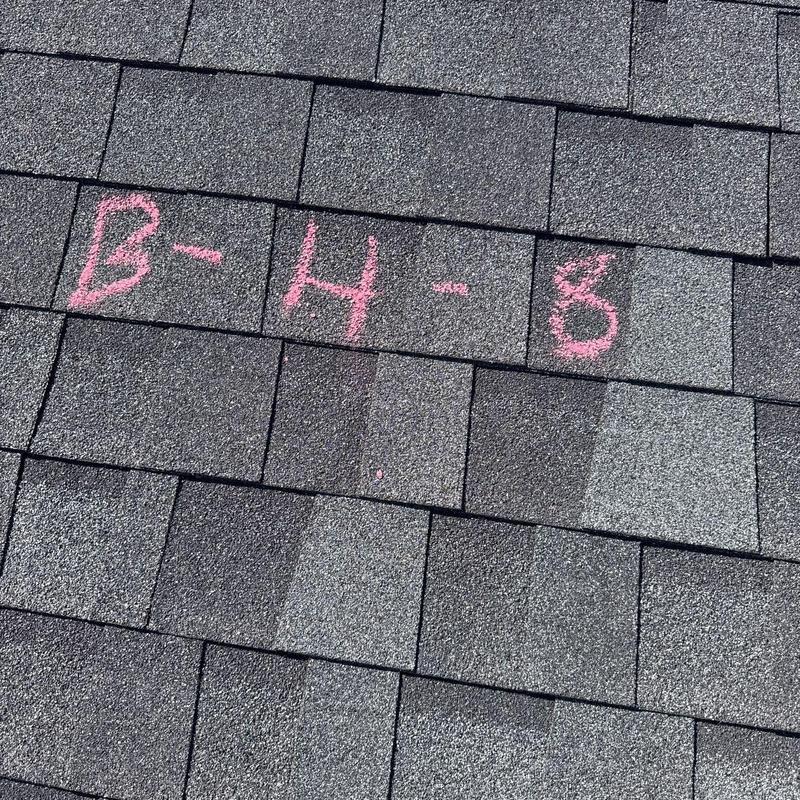 Asphalt roof shingles with hail damage markings