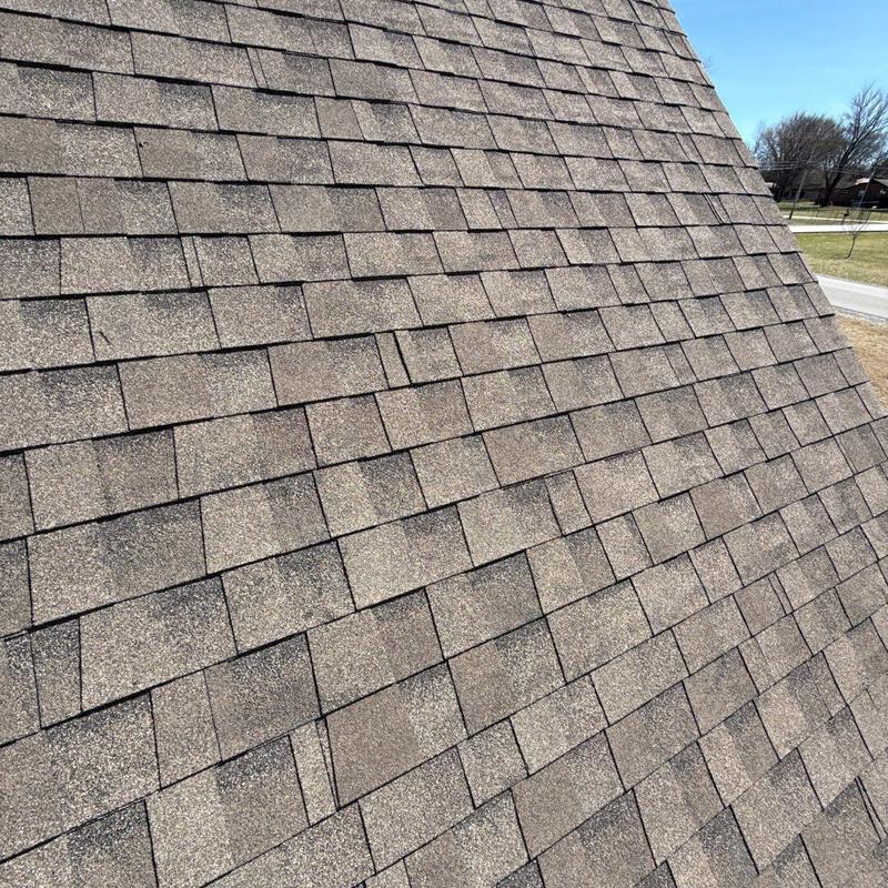 Asphalt shingles roof with hail damage and wear
