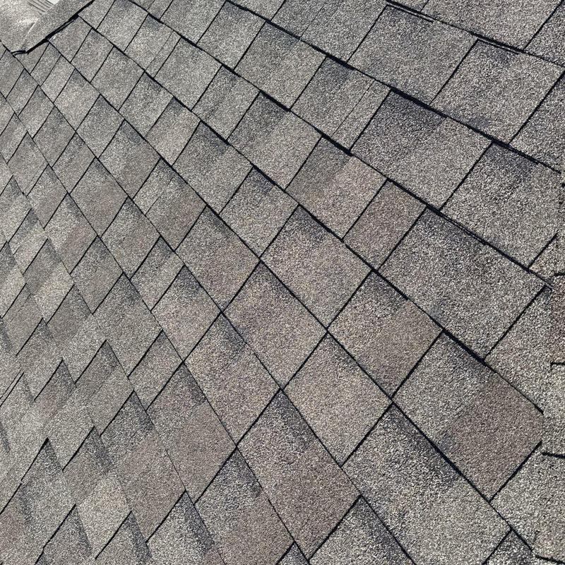 Asphalt shingle roof with hail damage inspection