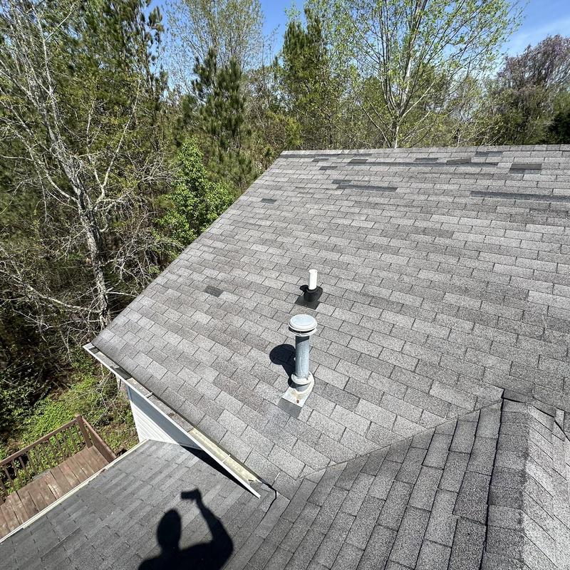 Asphalt shingle roof with damaged and missing shingles