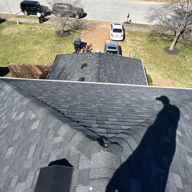 Asphalt shingle roof with ridge cap inspection shadow visible
