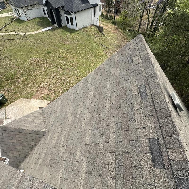 Roof shingles with visible damage and missing sections