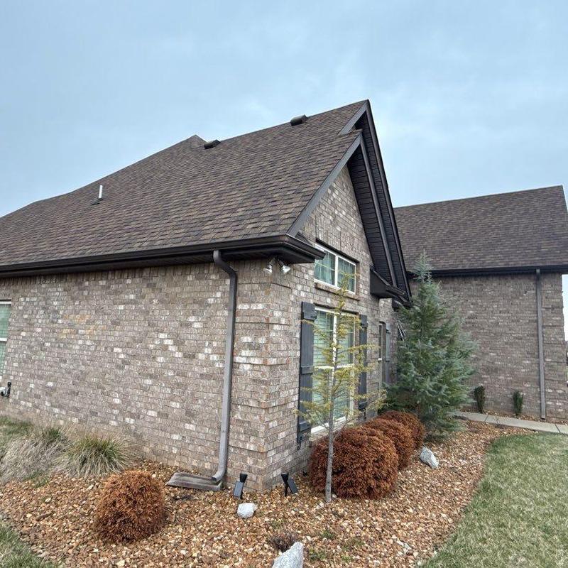 Asphalt shingle roof with gutter and landscaping