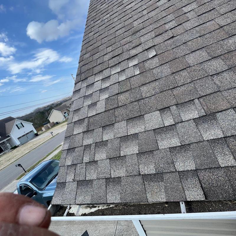 Asphalt shingle roof with hail damage inspection