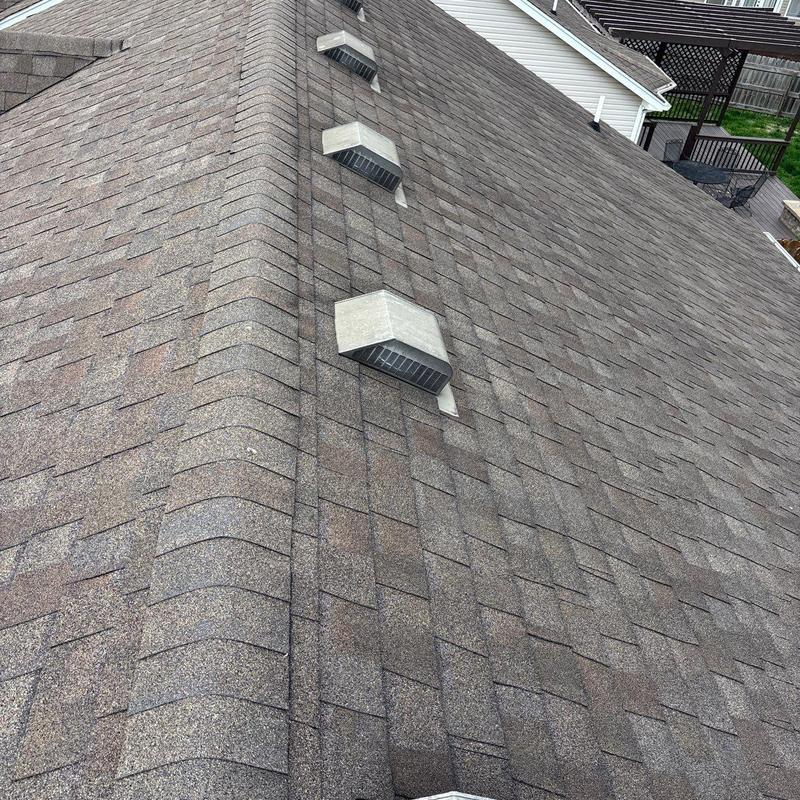 Asphalt shingle roof with ridge vents and roof vents
