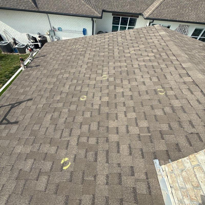 Asphalt shingle roof with hail damage marked