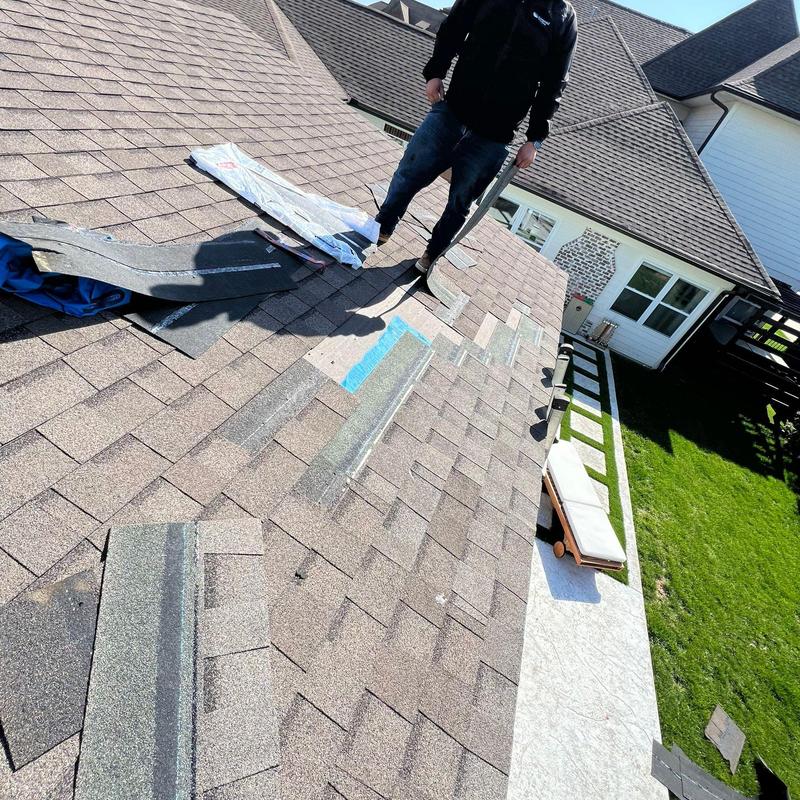 Asphalt shingle roof with replacement materials laid out