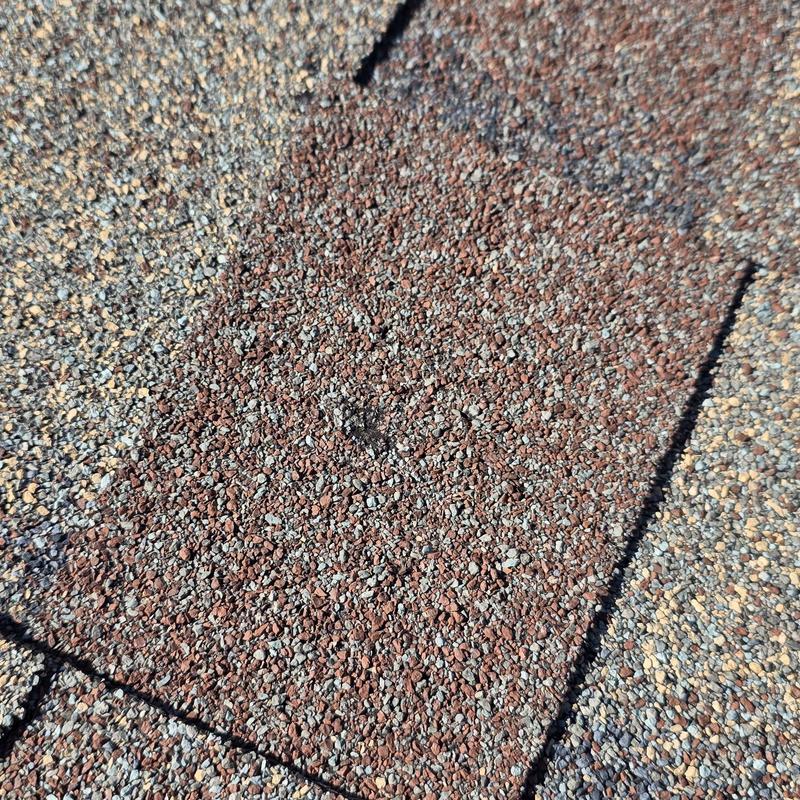 Asphalt roofing shingles with granule texture close-up