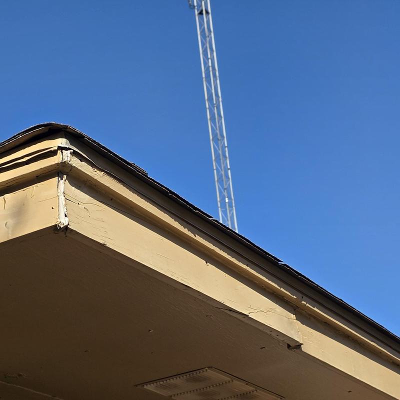 Roof edge and fascia hail damage under clear sky