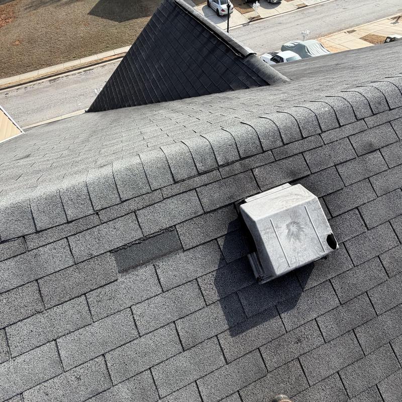 Roof shingles and box vent with damage on slate roof