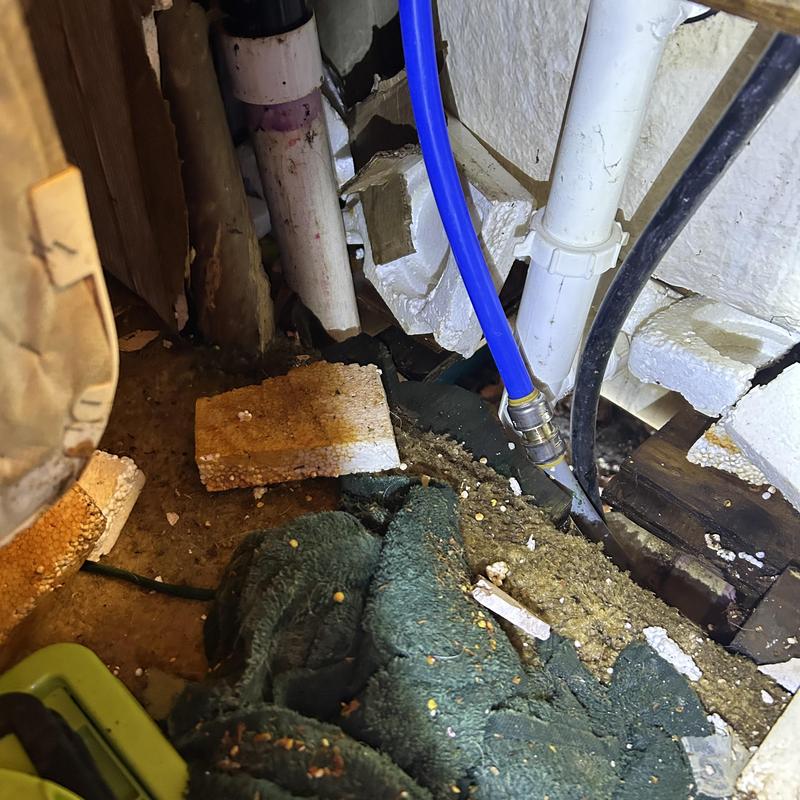 Burst water pipe with plumbing connections under floor