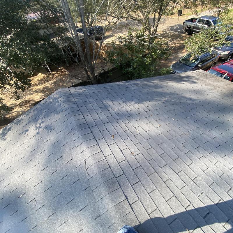 Asphalt shingle roof inspection with surrounding area visible Asphalt shingle roof inspection with surrounding area visible