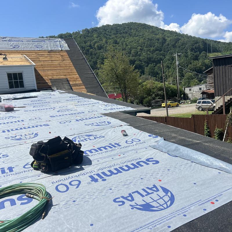 Roof underlayment with tools on residential roof in Blountville