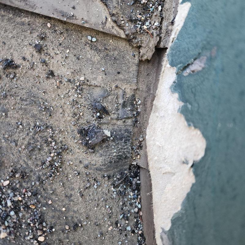 Step flashing near chimney with damaged shingles Step flashing near chimney with damaged shingles