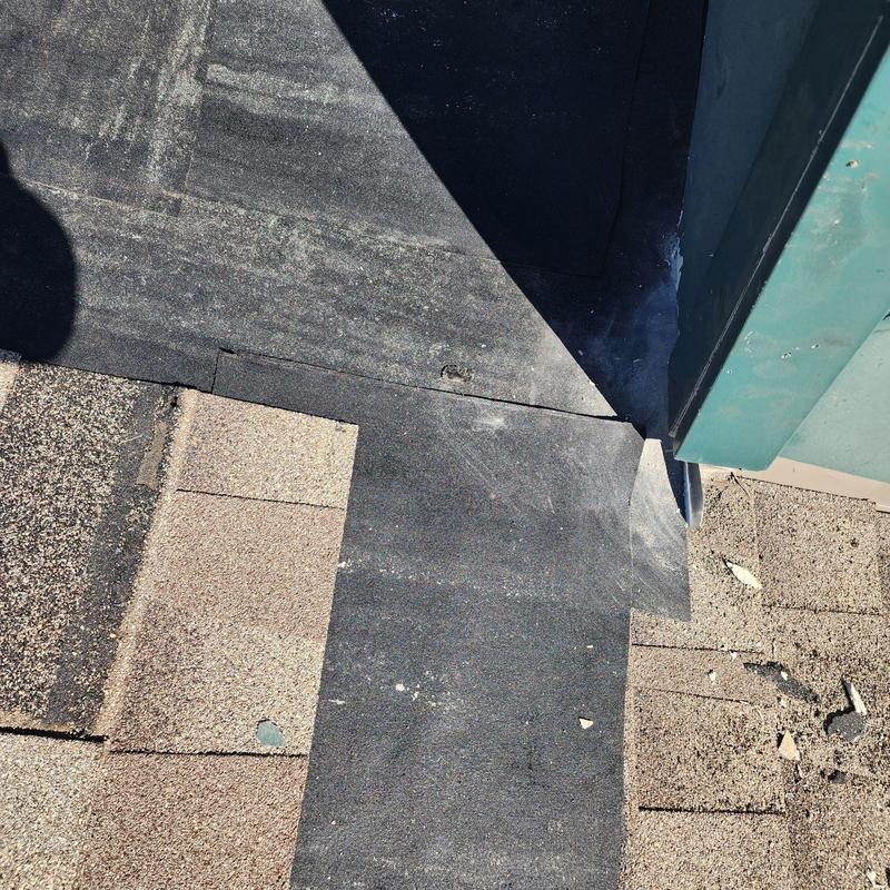 Step flashing at chimney and roof intersection with new installation Step flashing at chimney and roof intersection with new installation