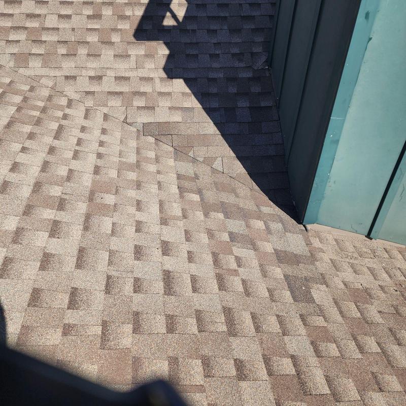 Step flashing and shingle installation near chimney base Step flashing and shingle installation near chimney base