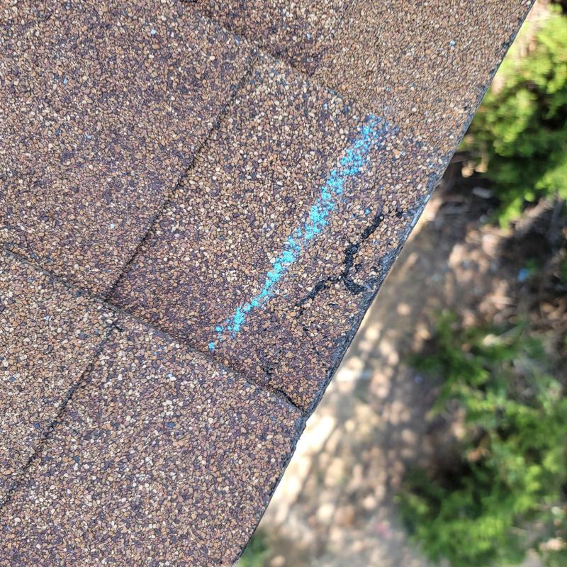 Roof shingles with edge damage and chalk markings Roof shingles with edge damage and chalk markings