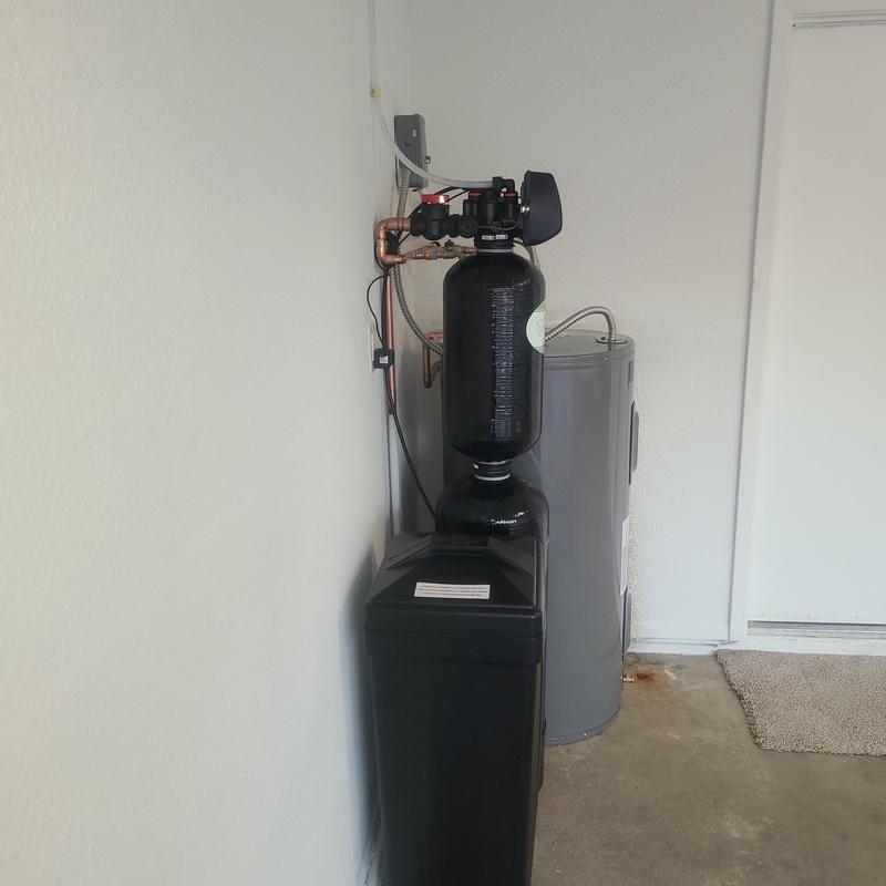 Water softener with filtration next to electric heater