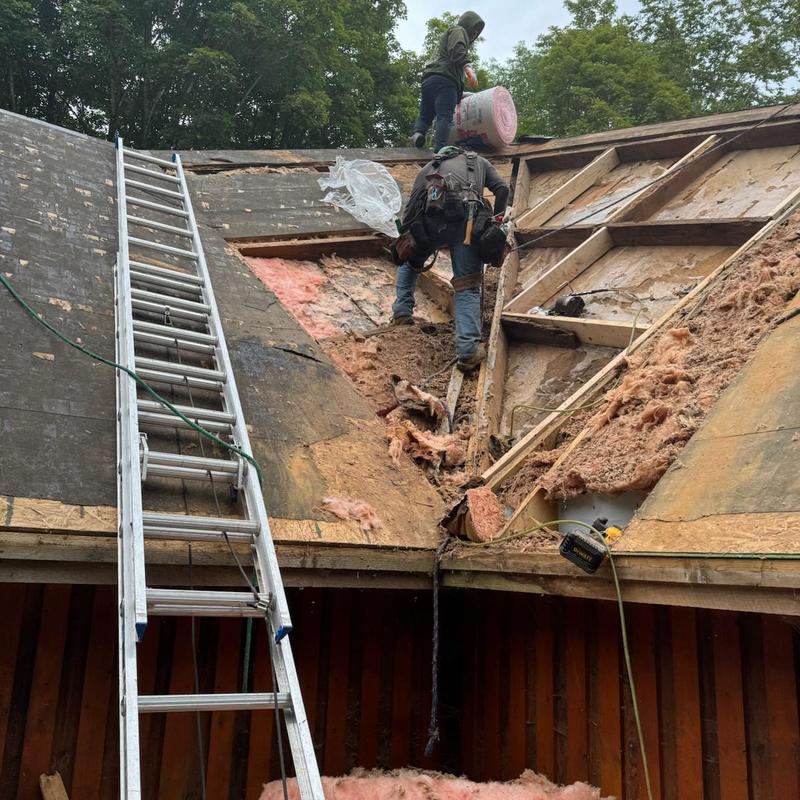 Roof decking removal and insulation work on steep roof