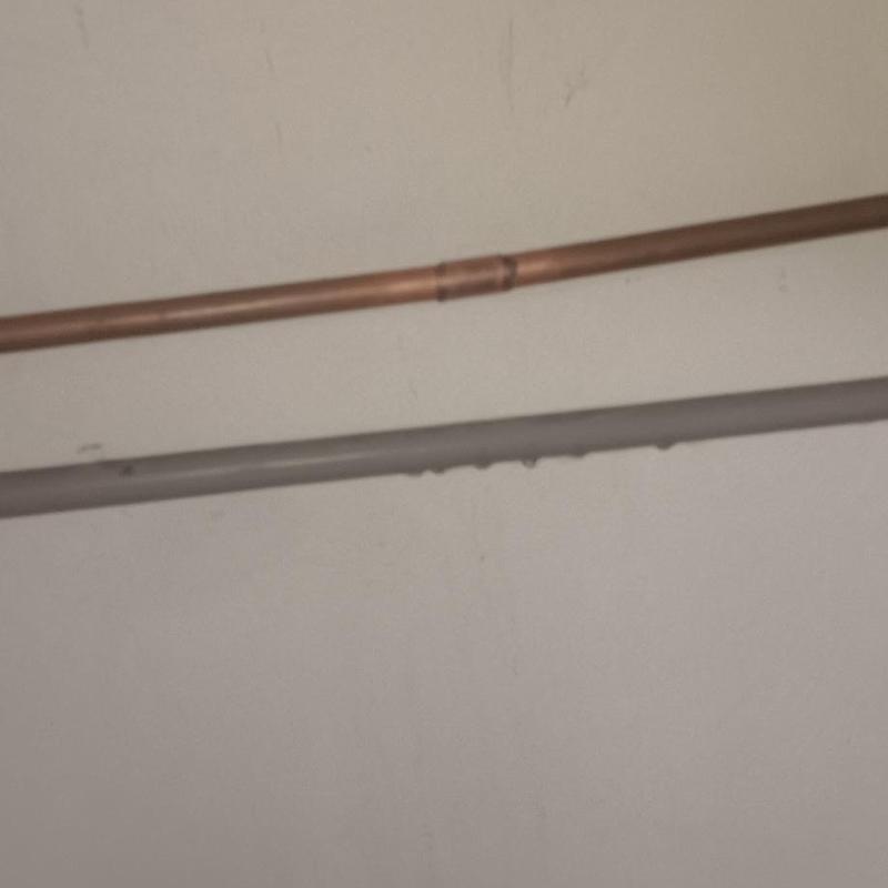 Copper plumbing pipe with soldered joint in wall