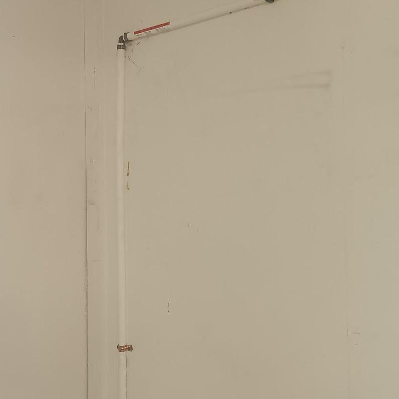 PVC water repipe along interior wall corner