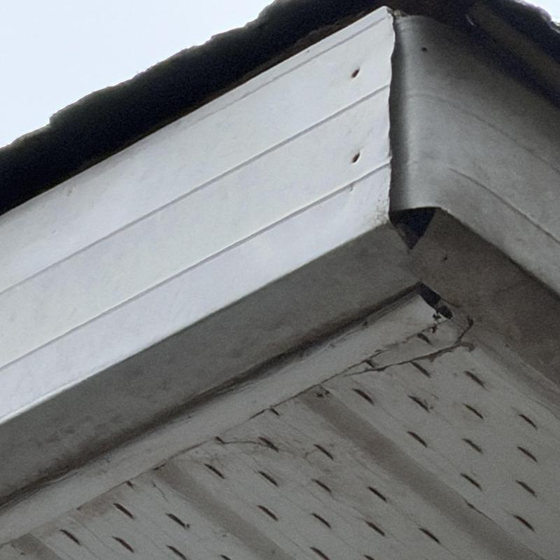 Metal fascia with missing nails on roof edge