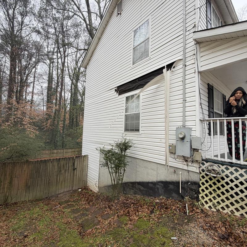 Vinyl siding and metal fascia damage on side house