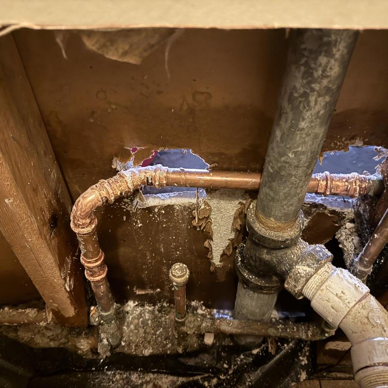 Copper water piping with fittings inside wall cavity