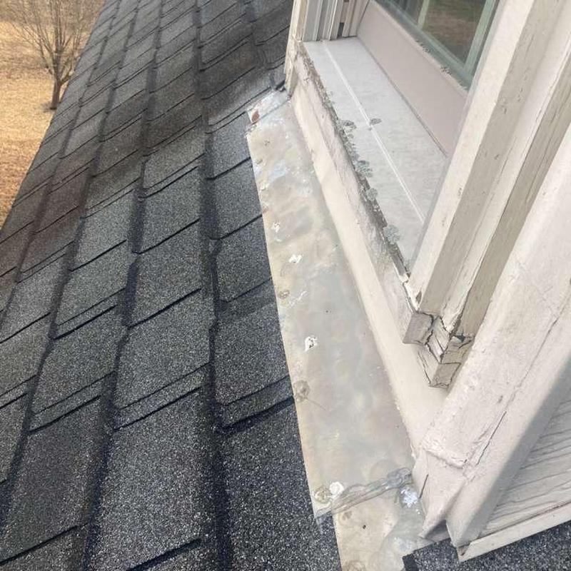 Asphalt shingle roof and metal flashing with hail damage