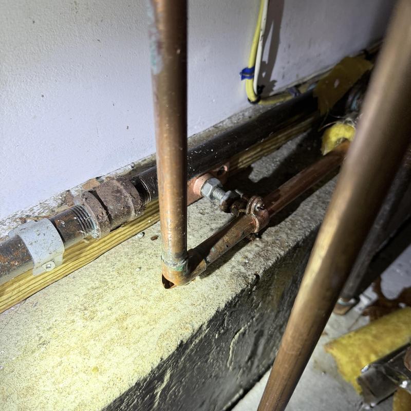 Copper water pipe with new valve installation in basement