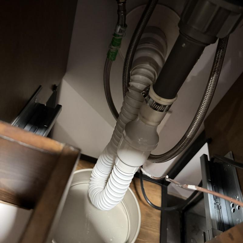 Flexible sink drain pipes with clamp under cabinet