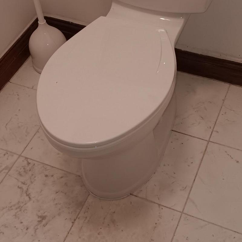 Toilet drain cable cleaning in bathroom corner