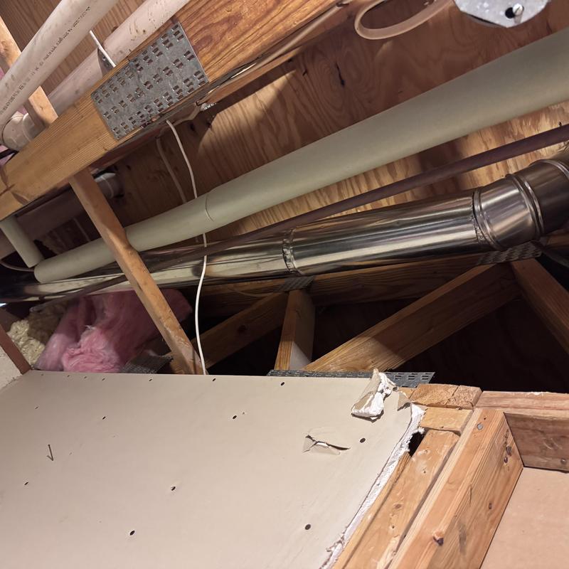 Rigid dryer vent and sewer pipe installation in attic