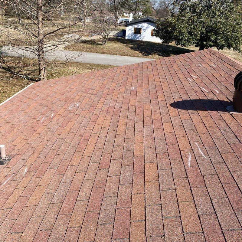Asphalt shingle roof with marked hail damage spots