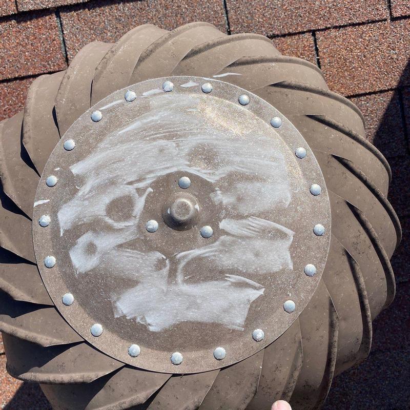 Turbine vent cap with weathering marks on roof shingles