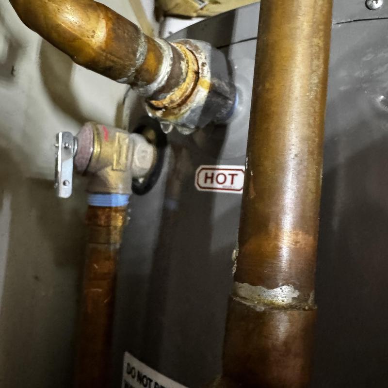 Hot water heater pipe and valve connections close-up