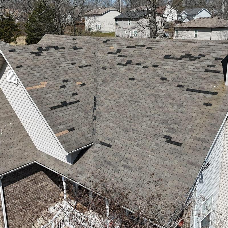 Asphalt shingle roof with hail damage spots