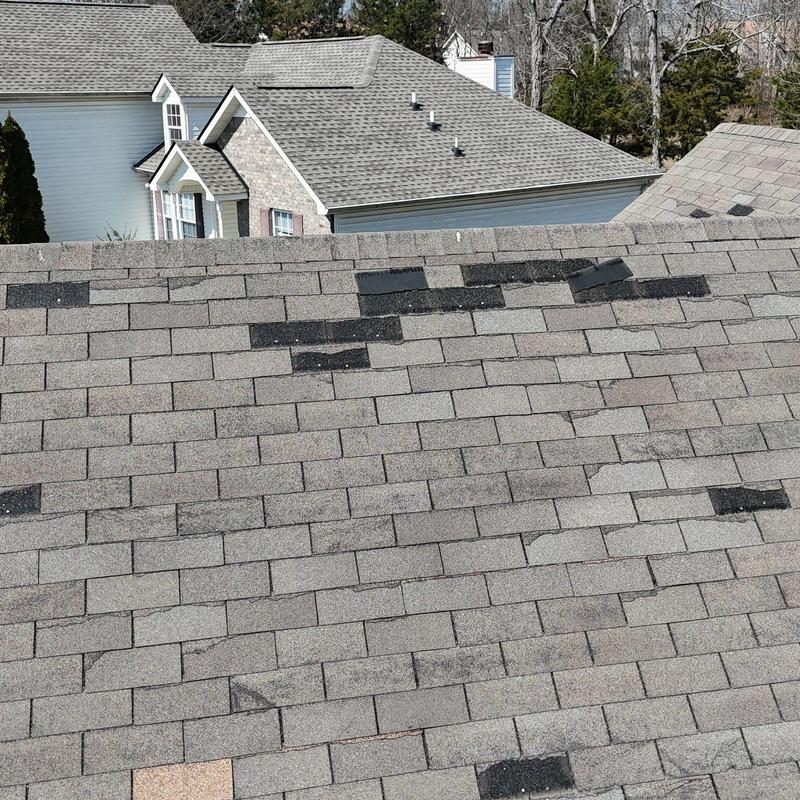 Asphalt shingle roof with hail damage and missing granules