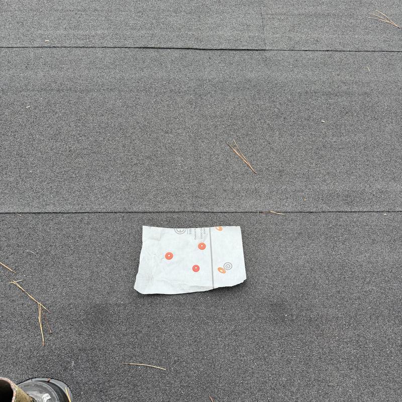 Rolled roofing with nail pop sealed and tarped